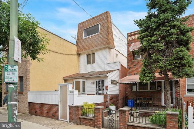 913 Tasker St, Philadelphia, PA 19148 - view of front of house featuring a fenced front yard, a porch, a gate, and brick siding