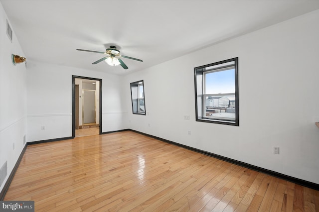 913 Tasker St, Philadelphia, PA 19148 - unfurnished bedroom with multiple windows, light wood-type flooring, and baseboards