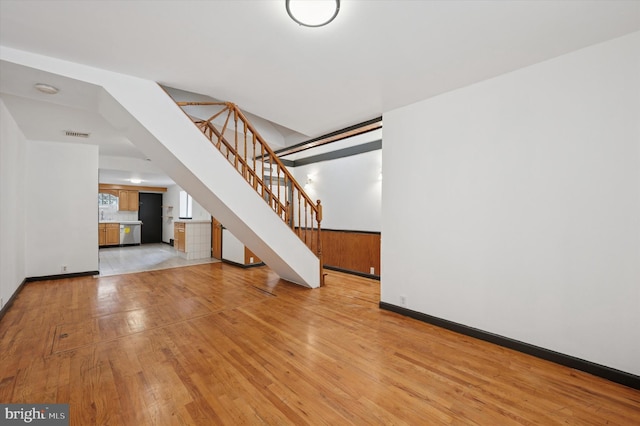 913 Tasker St, Philadelphia, PA 19148 - unfurnished living room with light wood-style floors, stairway, and baseboards