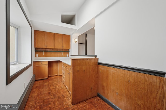 913 Tasker St, Philadelphia, PA 19148 - kitchen featuring a peninsula, brown cabinets, light countertops, and baseboards