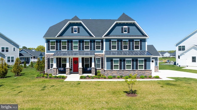 18234 Highwood Dr, Rehoboth Beach, DE 19971 - craftsman-style home with stone siding, covered porch, a standing seam roof, a front yard, and metal roof