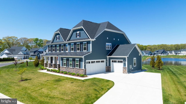 18234 Highwood Dr, Rehoboth Beach, DE 19971 - view of front facade with a standing seam roof, driveway, stone siding, an attached garage, and a water view