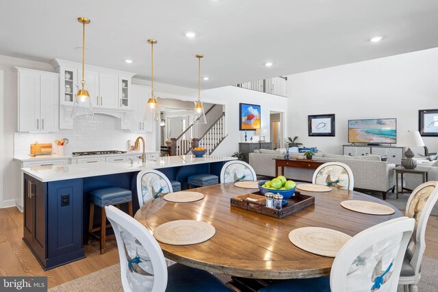 18234 Highwood Dr, Rehoboth Beach, DE 19971 - dining space featuring light wood-style flooring, stairs, and recessed lighting