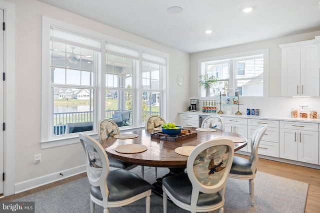 18234 Highwood Dr, Rehoboth Beach, DE 19971 - dining area featuring light wood finished floors, recessed lighting, baseboards, and a water view