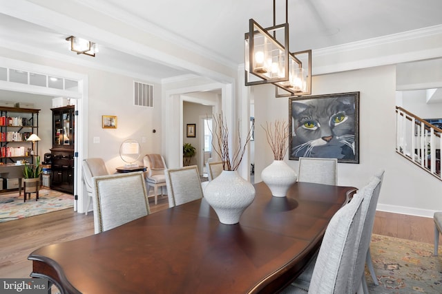 18234 Highwood Dr, Rehoboth Beach, DE 19971 - dining area with stairway, wood finished floors, and ornamental molding