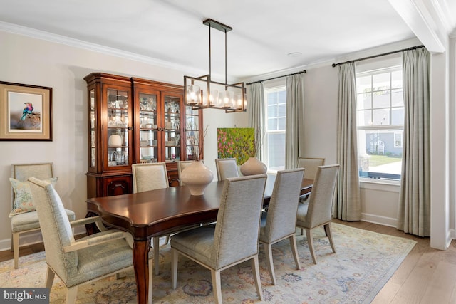 18234 Highwood Dr, Rehoboth Beach, DE 19971 - dining room featuring a chandelier, crown molding, light wood-type flooring, and baseboards