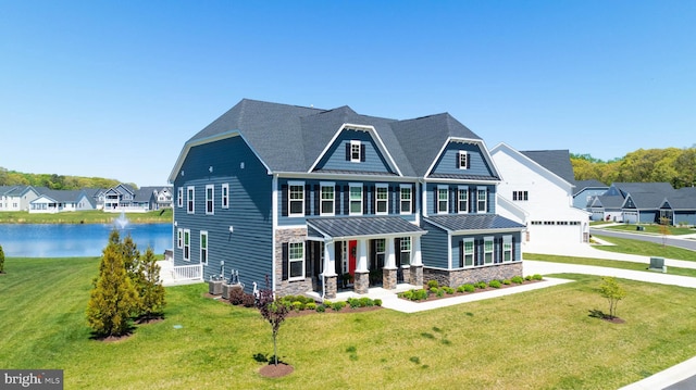 18234 Highwood Dr, Rehoboth Beach, DE 19971 - view of front facade with a porch, stone siding, a standing seam roof, a front yard, and a water view