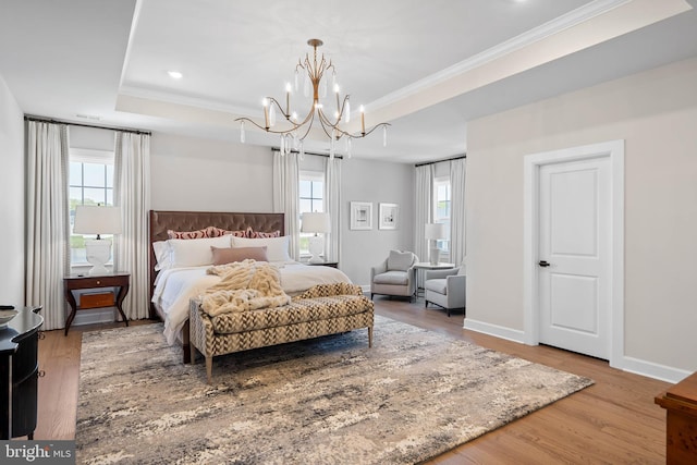 18234 Highwood Dr, Rehoboth Beach, DE 19971 - bedroom featuring a chandelier, ornamental molding, a raised ceiling, wood finished floors, and multiple windows