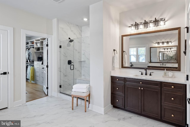 18234 Highwood Dr, Rehoboth Beach, DE 19971 - full bathroom featuring marble look tile flooring, a marble finish shower, baseboards, vanity, and a spacious closet