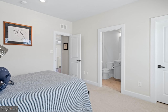 18234 Highwood Dr, Rehoboth Beach, DE 19971 - bedroom with light colored carpet, baseboards, and connected bathroom