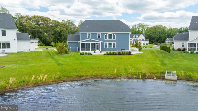 18234 Highwood Dr, Rehoboth Beach, DE 19971 - back of house featuring a lawn, a water view, and roof with shingles
