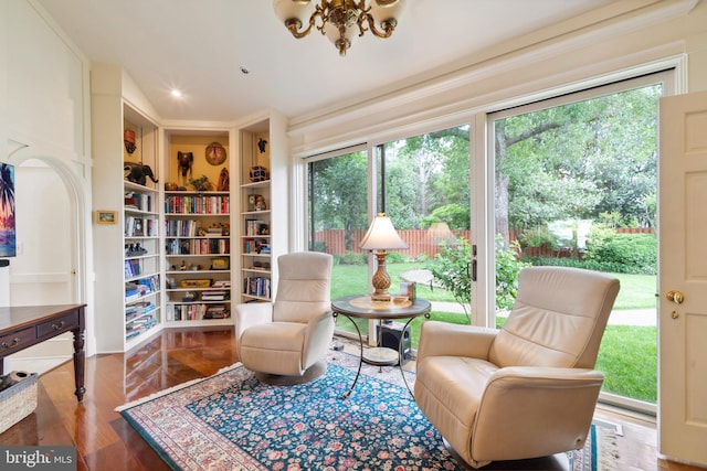 9791 Pintail Pl, Saint Michaels, MD 21663 - sitting room featuring plenty of natural light, built in features, a chandelier, and wood finished floors
