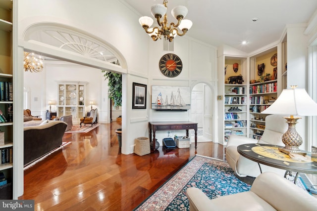 9791 Pintail Pl, Saint Michaels, MD 21663 - living area featuring a chandelier, wood finished floors, ornamental molding, high vaulted ceiling, and built in shelves