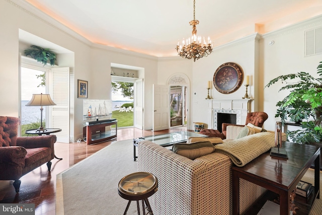 9791 Pintail Pl, Saint Michaels, MD 21663 - living room with a premium fireplace, a chandelier, crown molding, and wood finished floors