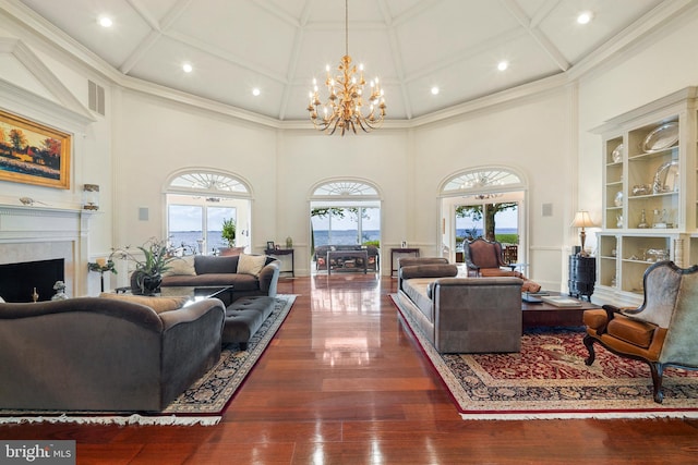 9791 Pintail Pl, Saint Michaels, MD 21663 - living area with a towering ceiling, coffered ceiling, a chandelier, a fireplace, and wood finished floors