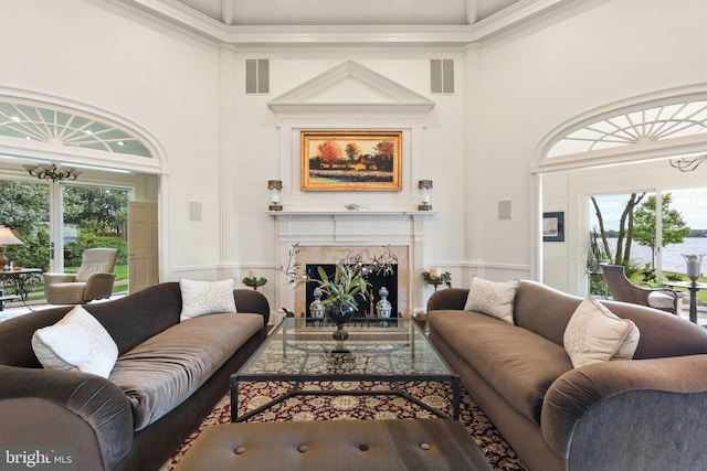 9791 Pintail Pl, Saint Michaels, MD 21663 - living room with a wainscoted wall, ornamental molding, a decorative wall, and a high end fireplace