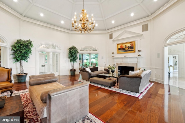 9791 Pintail Pl, Saint Michaels, MD 21663 - living area with a towering ceiling, coffered ceiling, recessed lighting, a high end fireplace, and wood-type flooring