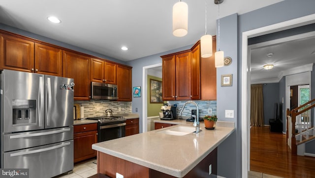 4000 Timber Oak Trl, Fairfax, VA 22033 - kitchen featuring appliances with stainless steel finishes, a sink, light countertops, a peninsula, and backsplash