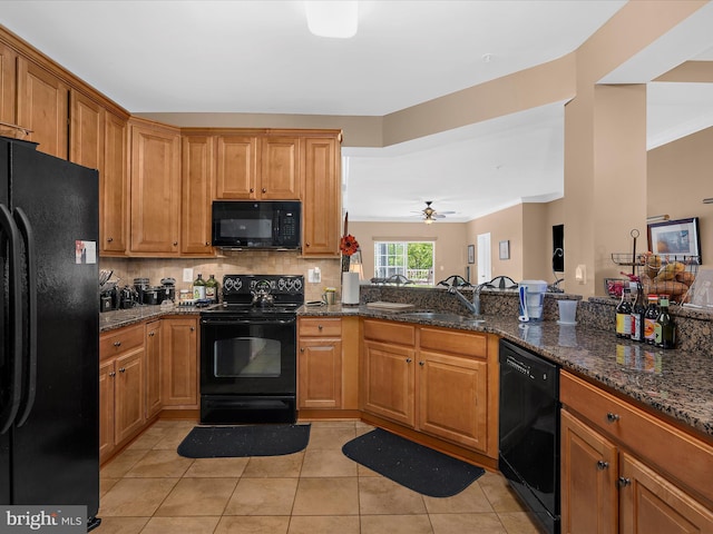 900 Marshy Cv Unit 111, Cambridge, MD 21613 - kitchen with black appliances, a sink, light tile patterned floors, decorative backsplash, and brown cabinets