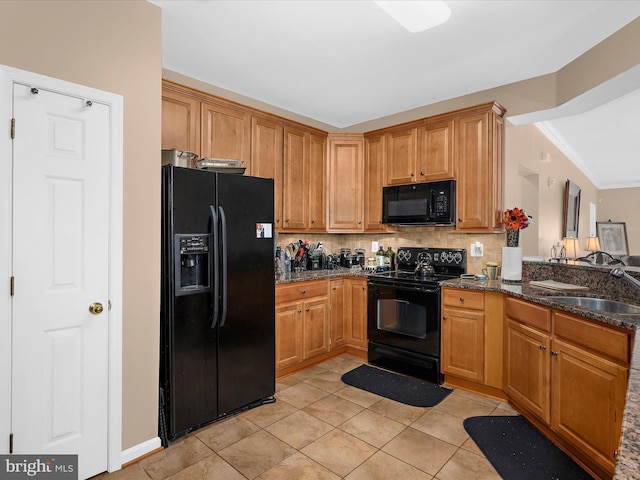 900 Marshy Cv Unit 111, Cambridge, MD 21613 - kitchen featuring black appliances, a sink, dark stone countertops, backsplash, and light tile patterned floors