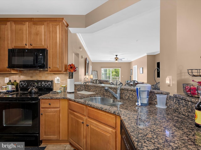 900 Marshy Cv Unit 111, Cambridge, MD 21613 - kitchen with black appliances, a sink, ornamental molding, dark stone counters, and a ceiling fan