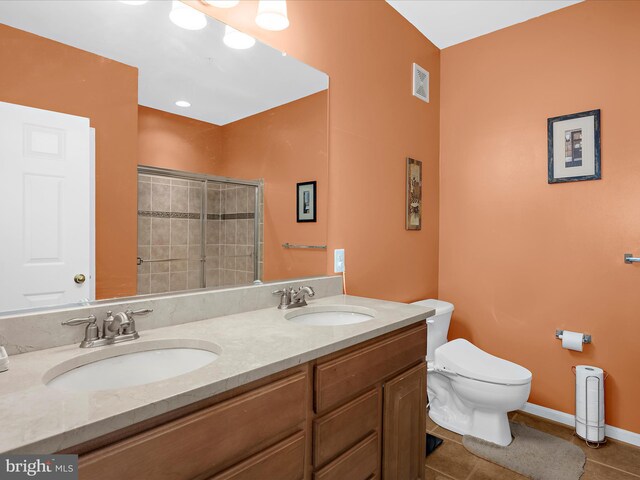 900 Marshy Cv Unit 111, Cambridge, MD 21613 - full bathroom with toilet, tile patterned floors, double vanity, a tile shower, and baseboards