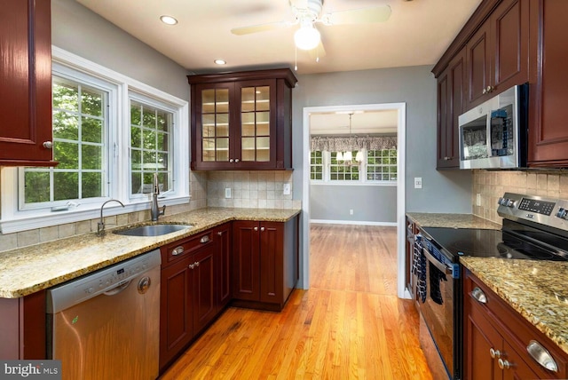 2410 Huntingdon Rd, Huntingdon Valley, PA 19006 - kitchen featuring stainless steel appliances, a sink, light wood-type flooring, backsplash, and light stone counters