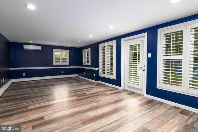 2410 Huntingdon Rd, Huntingdon Valley, PA 19006 - spare room featuring plenty of natural light, wood finished floors, a wall unit AC, recessed lighting, and baseboards