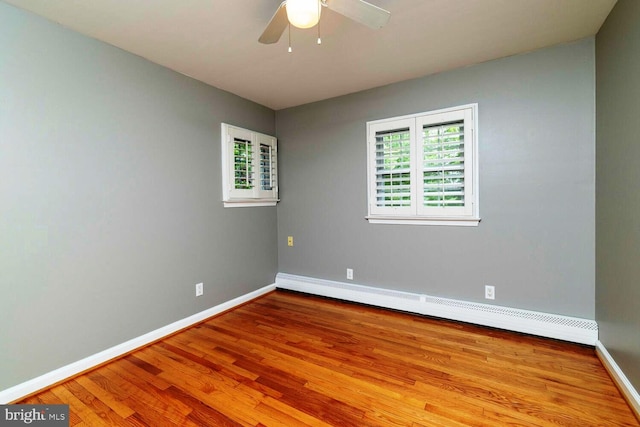 2410 Huntingdon Rd, Huntingdon Valley, PA 19006 - unfurnished room featuring wood finished floors, a baseboard radiator, plenty of natural light, and baseboards