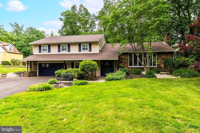 2410 Huntingdon Rd, Huntingdon Valley, PA 19006 - view of front of home featuring asphalt driveway, an attached garage, a front lawn, and stone siding