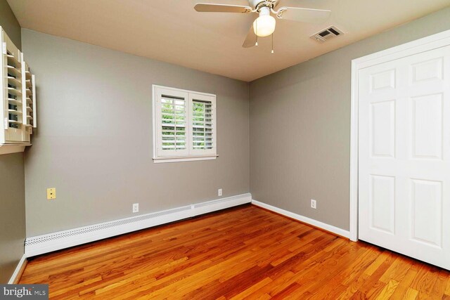 2410 Huntingdon Rd, Huntingdon Valley, PA 19006 - unfurnished bedroom with baseboard heating, light wood finished floors, baseboards, and ceiling fan