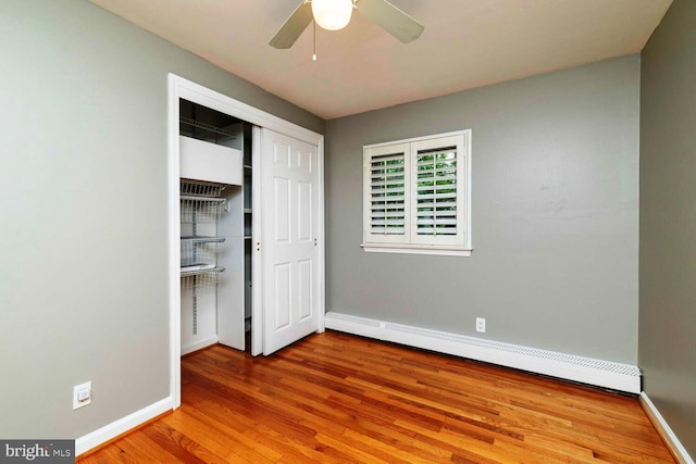 2410 Huntingdon Rd, Huntingdon Valley, PA 19006 - unfurnished bedroom with baseboard heating, wood finished floors, baseboards, and a closet