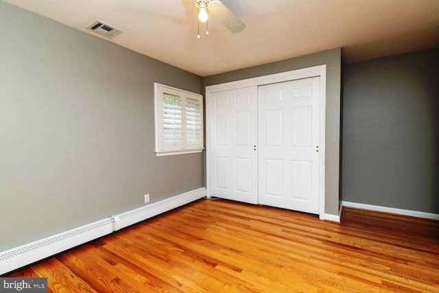 2410 Huntingdon Rd, Huntingdon Valley, PA 19006 - unfurnished bedroom with a baseboard radiator, baseboards, light wood-type flooring, and a closet