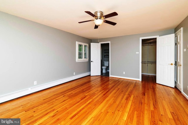 2410 Huntingdon Rd, Huntingdon Valley, PA 19006 - unfurnished bedroom with wood finished floors, a spacious closet, baseboards, a closet, and a baseboard heating unit