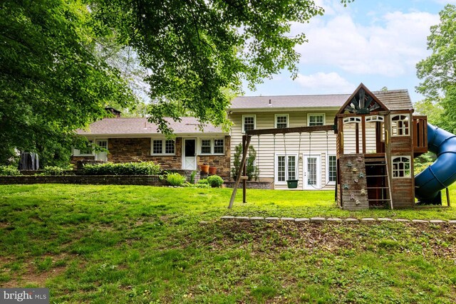 2410 Huntingdon Rd, Huntingdon Valley, PA 19006 - rear view of house with a playground, a lawn, and stone siding