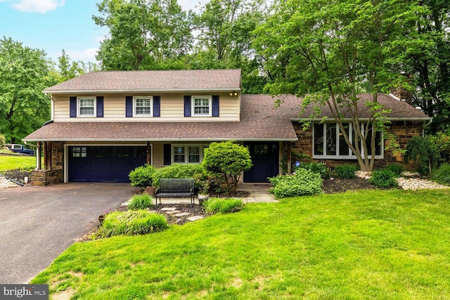 2410 Huntingdon Rd, Huntingdon Valley, PA 19006 - view of front of home with an attached garage, asphalt driveway, a front lawn, stone siding, and a shingled roof