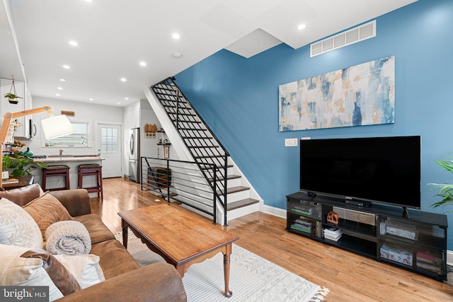 2117 Latona St, Philadelphia, PA 19146 - living room featuring stairs, light wood-style flooring, and recessed lighting