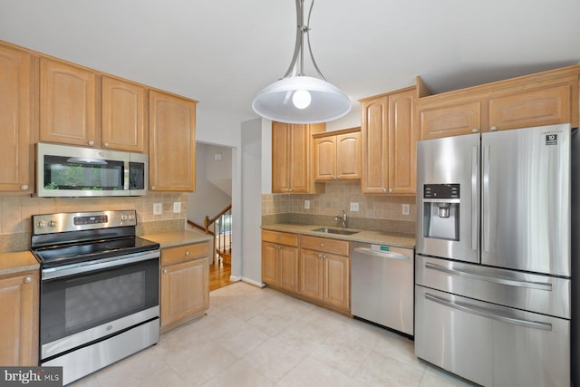 1515 Ainsley Rd, Silver Spring, MD 20904 - kitchen featuring stainless steel appliances, backsplash, light tile patterned floors, a sink, and hanging light fixtures