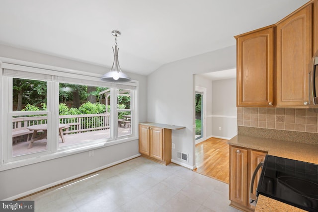 1515 Ainsley Rd, Silver Spring, MD 20904 - kitchen with stainless steel electric range oven, vaulted ceiling, tasteful backsplash, baseboards, and hanging light fixtures