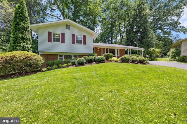 1515 Ainsley Rd, Silver Spring, MD 20904 - tri-level home featuring brick siding, a front lawn, and driveway