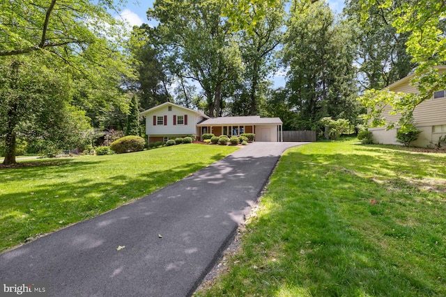 1515 Ainsley Rd, Silver Spring, MD 20904 - split level home featuring asphalt driveway, an attached garage, and view of wooded area