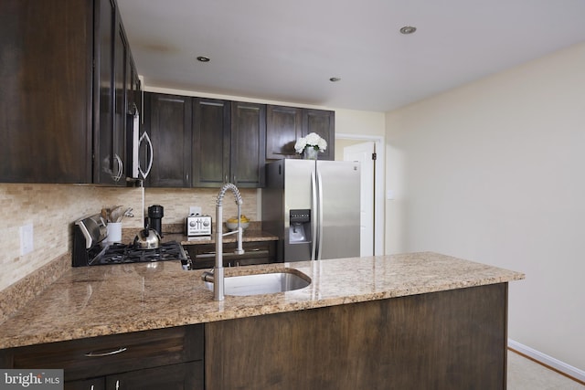 10893 Deborah Dr, Potomac, MD 20854 - kitchen featuring stainless steel appliances, a sink, dark brown cabinets, and light stone countertops