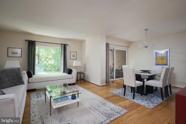10893 Deborah Dr, Potomac, MD 20854 - dining room featuring a chandelier, light wood finished floors, and baseboards