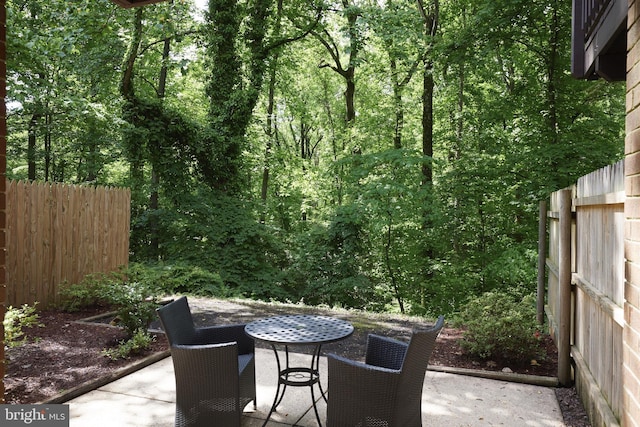 10893 Deborah Dr, Potomac, MD 20854 - view of patio / terrace with outdoor dining area and a wooded view