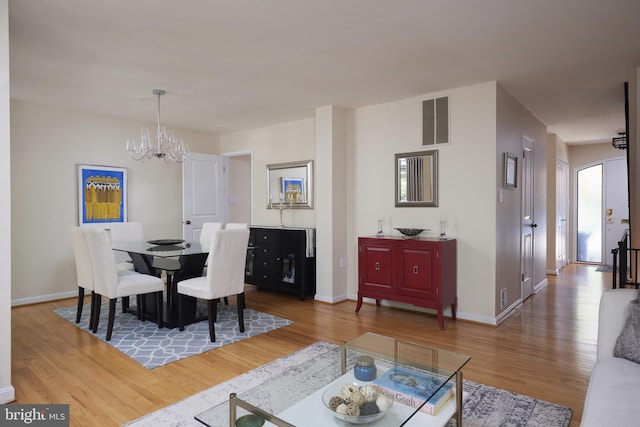 10893 Deborah Dr, Potomac, MD 20854 - dining area with wood finished floors, a chandelier, and baseboards