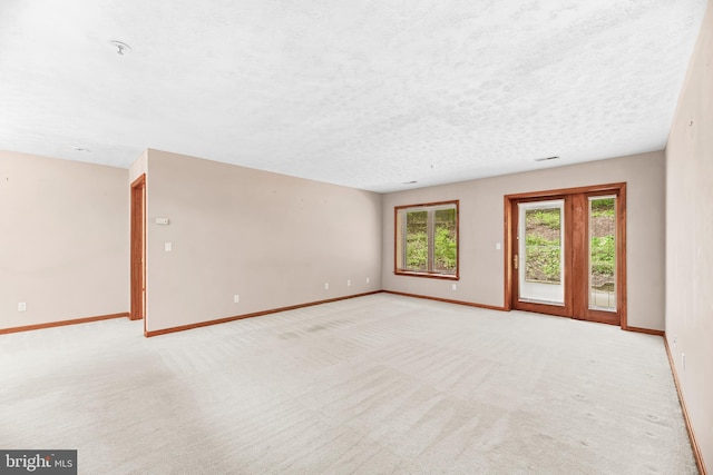 23140 Cobblestone Ln Unit 109, California, MD 20619 - spare room with baseboards, light carpet, a textured ceiling, and a pendent fire sprinkler