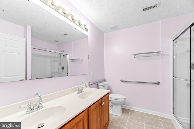 23140 Cobblestone Ln Unit 109, California, MD 20619 - bathroom featuring toilet, an enclosed shower, double vanity, baseboards, and tile patterned floors