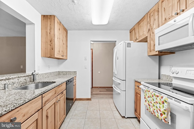 23140 Cobblestone Ln Unit 109, California, MD 20619 - kitchen with white appliances, light tile patterned floors, a sink, light stone counters, and a textured ceiling