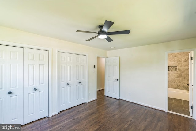 13029 Clarion Rd, Fort Washington, MD 20744 - unfurnished bedroom with multiple closets, dark wood finished floors, baseboards, ensuite bathroom, and a ceiling fan