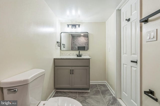 13029 Clarion Rd, Fort Washington, MD 20744 - bathroom featuring toilet, marble finish floors, vanity, and baseboards